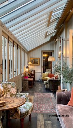 the inside of a house with many couches and chairs