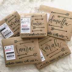 four brown bags with handwritten labels on them sitting on a white furnishing