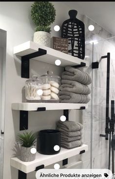 the shelves in this bathroom are filled with towels and other things to put on them