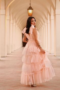 The Eliza is a more formal take on the classic puff dress. Be the belle of the ball with tiered ruffle layers, adjustable tulle bows and a smocked waist. This is the perfect occasion dress.Hana is wearing a size Small. She is 5’4” with a 32C bust and 25” waist. Tiered Pink Dress, Tulle Ruffle Prom Dress, Pink Tulle Bridesmaid Dress, Prom Dresses With Bows, Tulle Dress With Sleeves, Pink Puff Dress, Puffy Tulle Dress, 90's Prom, Feminine Esthetics