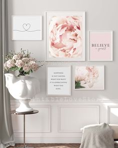 a white vase with flowers in it next to pictures on the wall and a chair