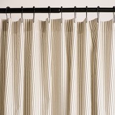 a striped curtain hanging from a metal rod