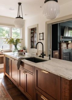 an instagramted photo of a kitchen with wood cabinets and marble counter tops, along with the words instagram