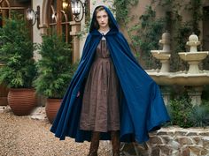 Introducing our cotton hooded unisex cape, a large two-layered hood leaves it with a wide and infinite mystery and adds dimension. Fabric sourced from cotton makes it lightweight, breathable, and flowing. It's a versatile accessory to elevate your look in many different ways: as a medieval cloak, renaissance fair cape, cosplay costume, historical setting costume, and a costume for a drama performance or photo shoot. ----Features--- Fabric: 100% Cotton  Closure: Cotton Tie The long train length: The length from the back of the neck to the hemline is 55" (140cm). The front of the cape is shorter falling gradually longer until the rear of the cape. Size: Free size  Color: Navy Blue Style: Classical two-layered hood ----Care---- This cotton cloak can be machine laundered on a short cycle with Ren Fair Cloak, Ren Faire Cape, Elf Cloak, Drama Performance, Velvet Cloak, History Bounding, Medieval Cloak, Ren Faire Costume, Costume Capes