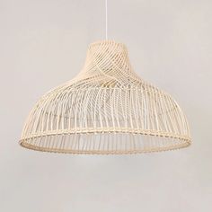 a white light hanging from a ceiling with wicker covering it's sides and bottom