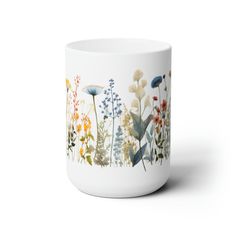 a white mug with flowers painted on it