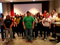 a group of people standing in front of a projector screen