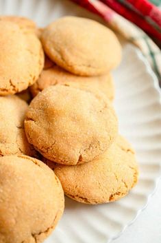 some cookies are on a white plate with red and green napkins in the background