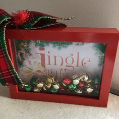 there is a red frame with bells in it and a bow on the top that says, jingle christmas