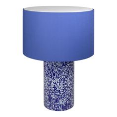 a blue and white vase with a light on it's side in front of a white background