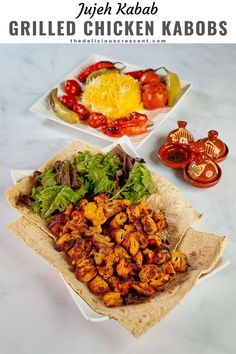 grilled chicken kabobs on pita bread with lettuce and tomatoes