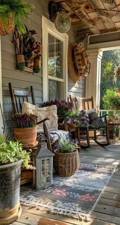 a porch with chairs and potted plants on it