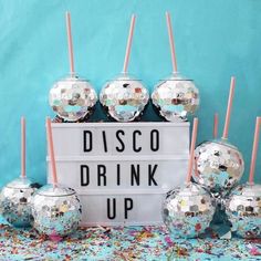 disco ball drink cups and straws in front of a sign that says disco drink up