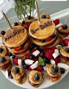 pancakes and berries are arranged on a plate