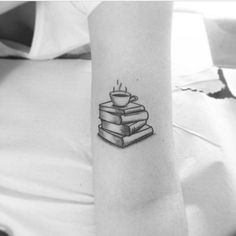 a person with a book tattoo on their arm and the words, i love books