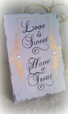 a sign that says love is sweet have a treat