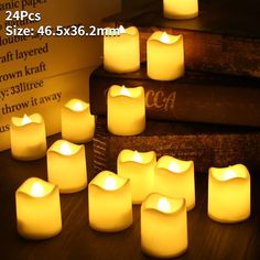 many lit candles sitting next to each other on a table