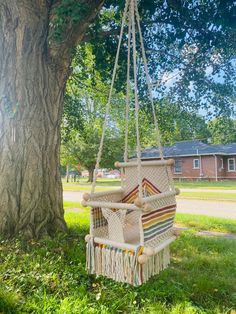 a hammock hanging from a tree in the grass