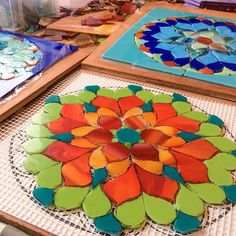 many different colored glass plates are on the table