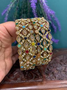 Antique bangle with multi color stone setting. Pearl and navratan style Monalisa polki work . Very unique design. About one inch wide. Comes in a pair. Designer item. Stone Setting, Color Stone, One Inch, Stone Settings, Stone Color, Cuff Bracelets, Unique Design, Multi Color, Bangles