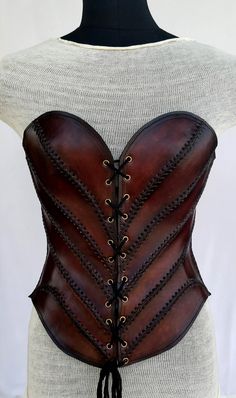 It is handmade leather corset with hand-sewn leather detailing. Fully adjustable at front with lace and back side with buckles. We used about 2 to 2.2 mm thick handmade leather. It is hand dyed handmade leather. It is crazy for medieval events and Larp.   Corset is hand made from sturdy top-grain leather.  Size is available from 30 to 36 inch, please check our size chart. bust size is in Size-chart.  DETAILS: ► 100% Handmade ► 100% Genuine leather ► Made on your measurements ► Unique design ► LA Diy Leather Corset, Leather Products Ideas Handmade, Female Leather Armor, Luxury Fitted Medieval Style Corset, Leather Armor Women, Luxury Leather Party Corset, Luxury Medieval Corset With Historical Design, Luxury Elegant Leather Corset, Brown Leather Corset