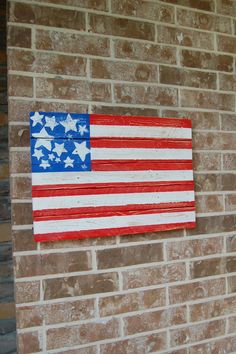 an american flag painted on a brick wall