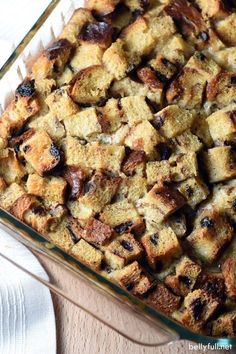 a casserole dish filled with bread and raisins