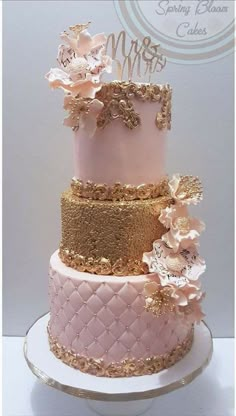 a three tiered pink and gold wedding cake