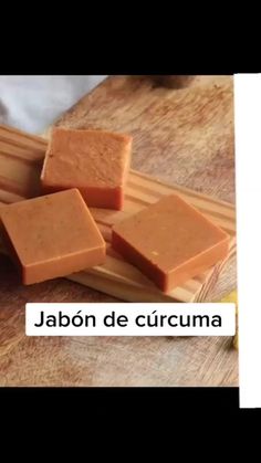 several pieces of soap sitting on top of a wooden cutting board