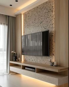 a living room with a flat screen tv mounted to the side of it's wall