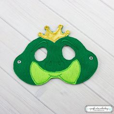 *Please read entire listing* These masks are great for Halloween, party favors, or just to pretend play around the house!!  *Mask Information* This listing is for 1 (one) Frog Prince Mask.  Comes with rivets attached, to make it a little more durable. Comes with round elastic cord cut to roughly 16-20 inches long, so you can cut the elastic to fit more comfortably on your child. Masks are roughly 5x7, depending on the design ordered. Please note: Most of the designs can fit a child up to 10. However, will vary between child and design.  Looking for adult sizes? Please personally contact me and ask if this design is available in adult size. Not all designs have that availability, but a lot haven't been listed yet. I'd love to help you out! May contain parts that are choking hazards. Do not Joyful Dress, Band Masks, Frog Mask, Felt Masks, Birthday Party Halloween, Commercial Embroidery Machine, Frog Princess, Party Favors Birthday, Felt Mask