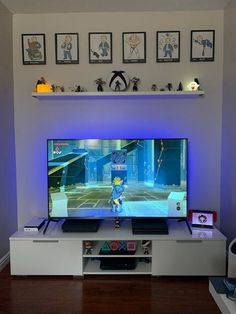 a flat screen tv sitting on top of a white entertainment center