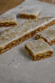 several pieces of food sitting on top of a piece of parchment paper next to each other