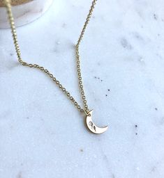 Celestial Botany I hand stamped a tiny flower onto this crescent moon pendant. The pendant measures 10 mm and is gold plated over silver The chain is a durable and high quality gold plated brass material with three adjustable lengths (16,17,&18 inches) We have so many moon pieces, check out Our shop to see the rest 🌒 Have a wonderful summer 🌸 Delicate Crescent Moon Phase Jewelry, Delicate Crescent Moon Charm Necklace, Dainty Crescent Moon Charm Necklace, Delicate Half Moon Jewelry With Moon Phase Detail, Dainty Crescent Jewelry With Delicate Chain, Dainty Crescent Charm Necklaces For Everyday, Dainty Crescent-shaped Jewelry With Delicate Chain, Everyday Crescent Moon Charm Necklaces, Everyday Crescent Moon Phase Charm Necklace