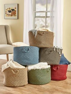 several baskets stacked on top of each other in front of a window