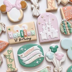 some decorated cookies are laying out on a white surface with the words happy 1st birthday