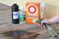 someone is pouring baking soda into a glass bottle on a wooden table next to bottles of baking soda