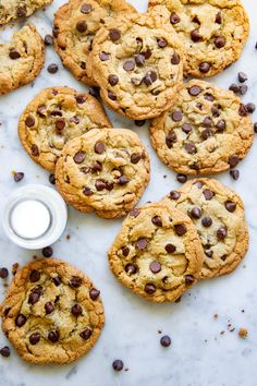 chocolate chip cookies and milk on a marble surface