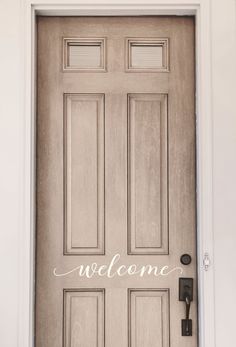 a welcome sign on the front door of a house