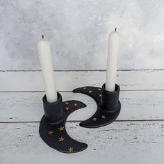 two candles are placed in the shape of a crescent with stars and moon on it