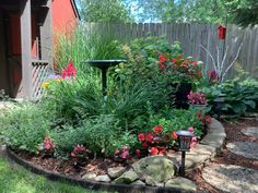 a garden with rocks and flowers in it