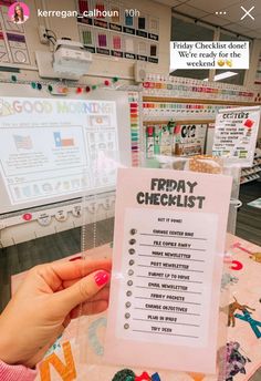 a person holding up a friday checklist on a table