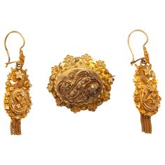 This is an antique early 20th century jewelry set consisting of earrings and a brooch. The gold has beautiful cannetille work set with wire work knots and stars. In the Netherlands, these knots are also-called 'spiders', the body in the center surrounded by its legs. These jewels show an abundant scene of fine cannetille work. The earrings and brooch have a lovely decoration and the borders have scalloped edges. The spiral wire work on the earrings are also know as cornucopia, which means abundance. Underneath the earrings dangling tassels are hung. This kind of jewelry was worn by women around 1900 in the southern part of The Netherlands, in Brabant. The set is in good condition. Marked and tested as 14k gold. The back of the brooch has a base metal pin and has some small solder spots. Br Gold Hat, Gold Tassel Earrings, Gold Jewelry Set, Earrings Dangling, Gold Jewelry Sets, Yellow Gold Jewelry, The Spiral, Brooch Jewelry, Gold Filigree