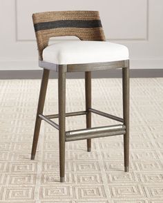 an upholstered bar stool with a striped seat cushion