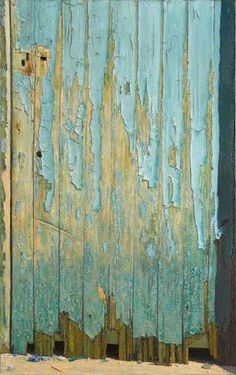 an old wooden door with peeling paint on it