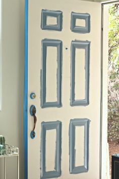 the door is painted white and has blue trim