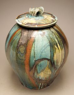 an artisticly designed ceramic jar with lid