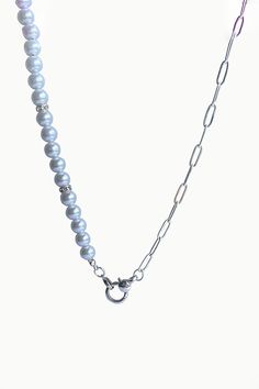 A brand new entry to our summer jewels collection, Mika necklace showcases a strand of lustrous white pearls, silver zircon spacers and sterling silver paperclip chain, elegantly secured with a silver anchor clasp. Pair Mika with delicate pearl earrings to achieve a perfectly coordinated look. White Freshwater Pearls Zircon Studded Silver Spacers Paperclip Chain - Sterling Silver Pearl: Love - Beauty - Wealth Anchor Silver Clasp Pearl Size: 6mm apx. Necklace Length: 20" Elegant Silver Necklace With Paperclip Chain, Elegant Silver Pearl Necklace For Everyday, Elegant Everyday Silver Pearl Necklace, Everyday Silver Pearl Chain Necklace, Everyday Silver Jewelry With Pearl Chain, Elegant Silver Pearl Necklace With Chain, Classic Silver Chain Necklace With Pearls, Elegant Pearl Chain Necklace With Silver Chain, Silver Pearl Necklace With Chain