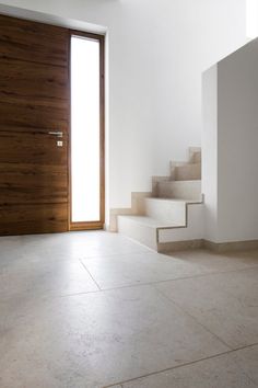 an empty room with steps leading up to the door