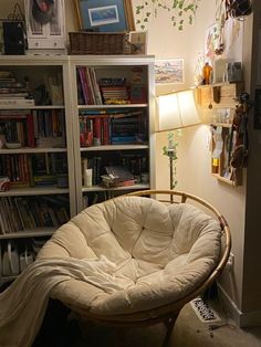 a living room filled with furniture and bookshelves next to a wall mounted book shelf